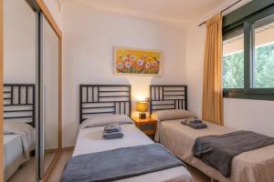 A bed or beds in a room at Playa Marina by Ĥ