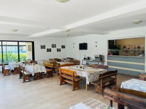 a restaurant with tables and chairs and a kitchen at Maria Garden in Kranevo