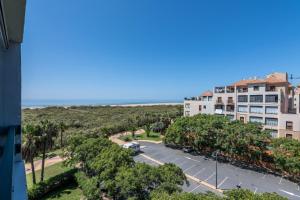 a view of the beach from the balcony of a building at Las Palmeras by Ĥ - Playa Punta del Moral PLHP28P11 in Isla del Moral