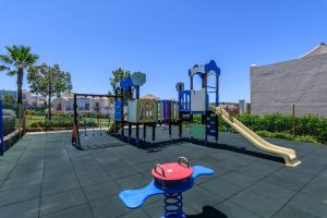 ein Spielplatz mit einer Rutsche und einem roten Spielzeug in der Unterkunft Vista Hermosa by H - Costa Esuri EVHH167P00 in Ayamonte