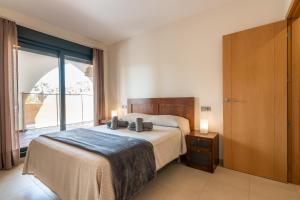 A bed or beds in a room at Playa Marina by Ĥ