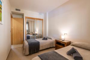 A bed or beds in a room at Playa Marina by Ĥ