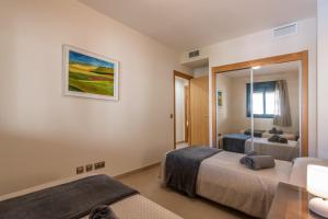 A bed or beds in a room at Playa Marina by Ĥ
