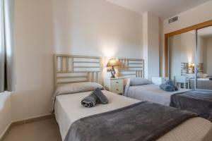 A bed or beds in a room at Playa Marina by Ĥ