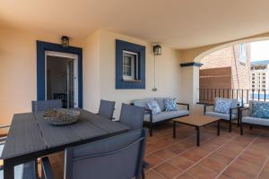 eine Terrasse mit Tisch und Stühlen auf einem Balkon in der Unterkunft Marina I PLUS by Ĥ - Marina Isla Canela PMHI57P28 in Punta del moral