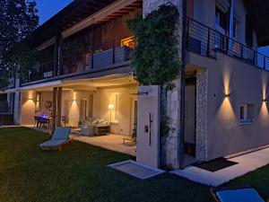 a view of a house with a patio at night at Villa dell'Olivo Bianco in Castion Veronese