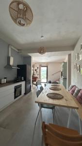 a kitchen and living room with a table and a couch at Il Verdone in Usini