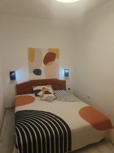 a bedroom with a large bed with a colorful bedspread at apartman Ante in Kaštela