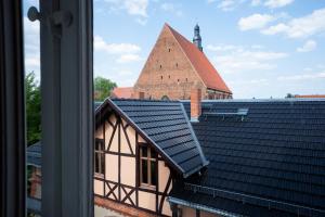 a view from a window of a building with a roof at Bürgermeisterhaus Jüterbog - Gästeapartments am Kulturquartier in Jüterbog