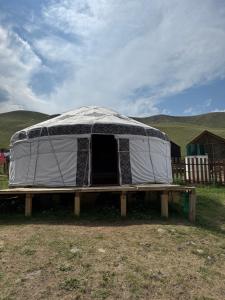 a tent sitting on a table in a field at Юрты РАЯНА in Kurmenty