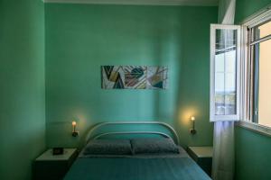a green bedroom with a bed and a window at Welcome to our Home Villetta Baia Verde Gallipoli in Baia Verde