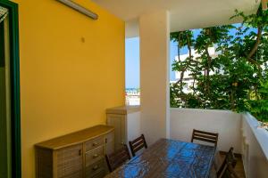 a dining room with a table and chairs and a window at Welcome to our Home Villetta Baia Verde Gallipoli in Baia Verde +88 photos