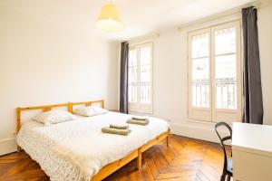 a bedroom with a bed with two towels on it at 6 Guests Flat - Montparnasse in Paris