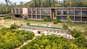 an external view of a building with chairs and a pool at inchantreedoolay huahin in Pran Buri
