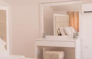 a white bathroom with a sink and a mirror at Sea side apartment in Kotor +24 photos