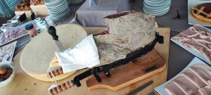 a table topped with a wooden table with a piecussioncussioncussioncussioncussioncussion at B&B Promenade Hotel Simple con Piscina in Milano Marittima +36 photos