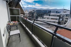 a balcony with a table and a view of a building at Above & Beyond Volos City Center Luxury Redefined in Volos