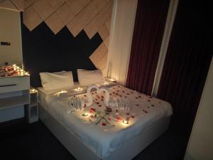 a bedroom with a bed with candles and lights on it at Danzha Motel Erbil in Erbil