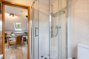 a bathroom with a shower with a glass door at Ferienwohnung Zur alten Säge in Dresden +24 photos