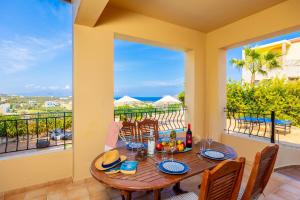 a dining room with a table and a balcony at Villa Pasiphae 1 in Stalos