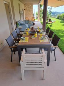 a wooden table and chairs on a patio at Villa dell'Olivo Bianco in Castion Veronese