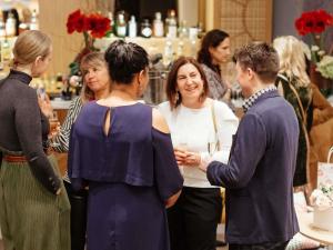 a group of people standing around each other in a store at Croisette Beach Hotel Cannes - MGallery Collection in Cannes