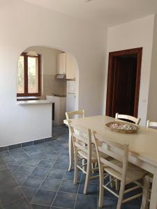 a kitchen and dining room with a table and chairs at Trilo Lu Rattali in San Teodoro +31 photos