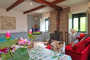 a living room with a red couch and a table at Bed and breakfast EXCLUSIVE & Luxury Traditional Portuguese Farmhouse 