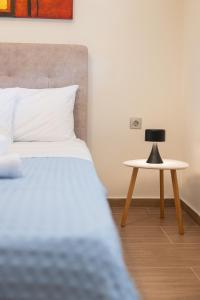 a bedroom with a bed and a side table at Balance Suite in Kourouta