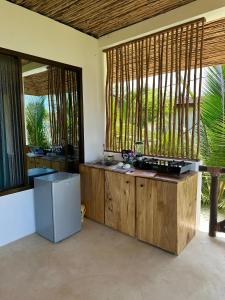 a kitchen with a counter and a refrigerator in a room at Sand Beach Boutique Apartments in Bwejuu +9 photos