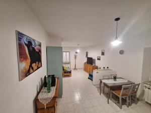 a kitchen and living room with a table and a dining room at Alloggio Turistico Pescaxiause in SantʼOreste +2 photos