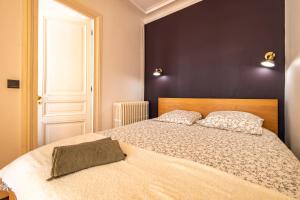 a bedroom with a large bed with two pillows at 4 Guests Flat - Turbigo in Paris +8 photos