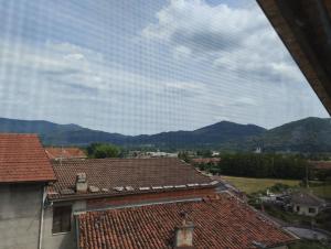 a view of the mountains from the roofs of houses at Mansarda Giaveno in Giaveno