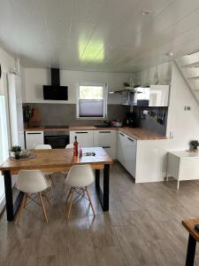 a kitchen with a table and chairs in a room at Ferienhaus Zee-Tijd in Herkingen
