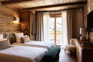 Ένα ή περισσότερα κρεβάτια σε δωμάτιο στο Les Chalets de la Source 3 - Luxe - Skis aux pieds - 12 personnes