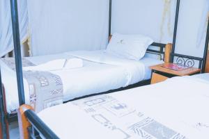 Postel nebo postele na pokoji v ubytování LAZARUS KAKA CBD Accomodations