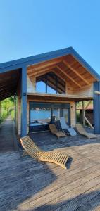 a house with a deck with chairs on it at CabinAtRiver Ada Bojana in Ulcinj