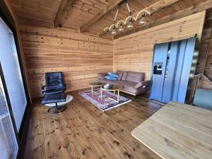 a living room with a couch and a chair at CabinAtRiver Ada Bojana in Ulcinj