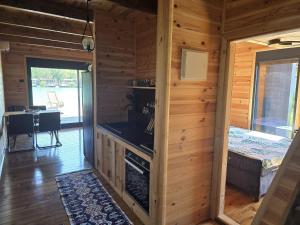 a wooden cabin with a kitchen and a dining room at CabinAtRiver Ada Bojana in Ulcinj