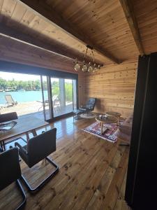 a living room with wooden floors and a large window at CabinAtRiver Ada Bojana in Ulcinj