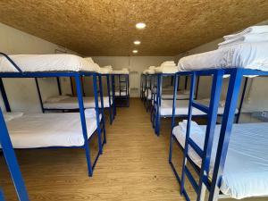 a row of bunk beds in a room at Albergue Naturmaz in Mazaricos