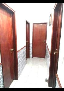 a hallway with two wooden doors in a room at Lisbon Private Room near airport in Lisbon