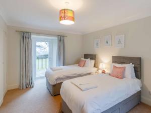 two beds in a room with a window at 2 Bed in Blair Drummond 81513 in Doune