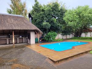 a swimming pool in front of a building at Stay at 126 in Bloemfontein