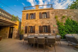 a patio with a table and chairs in front of a building at Buyan Han in Ayvacık