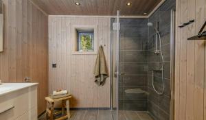 a bathroom with a shower with a glass door at Modern Cabin With Beautiful Design By Gålåvatn in Gålå