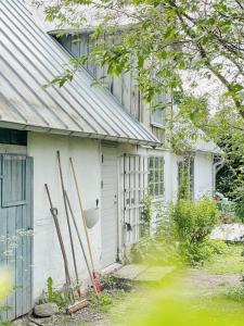 a house with some skis leaning against the side of it at Timber-Framed House With Organic Farm In Nature in Stehag