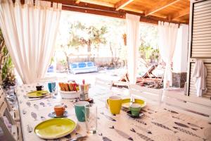 a table with a plate of food on it at Casa Josto - Walk to Maladroxia Beach private garden in Maladroscia