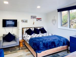 a bedroom with a bed and a tv and a chair at 1 Bed in Kinlochleven 87131 in Kinlochleven