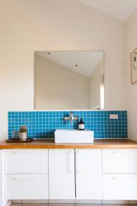 a bathroom with a sink and a mirror at West Jutland In Peaceful Havblik Setting in Nørlev
